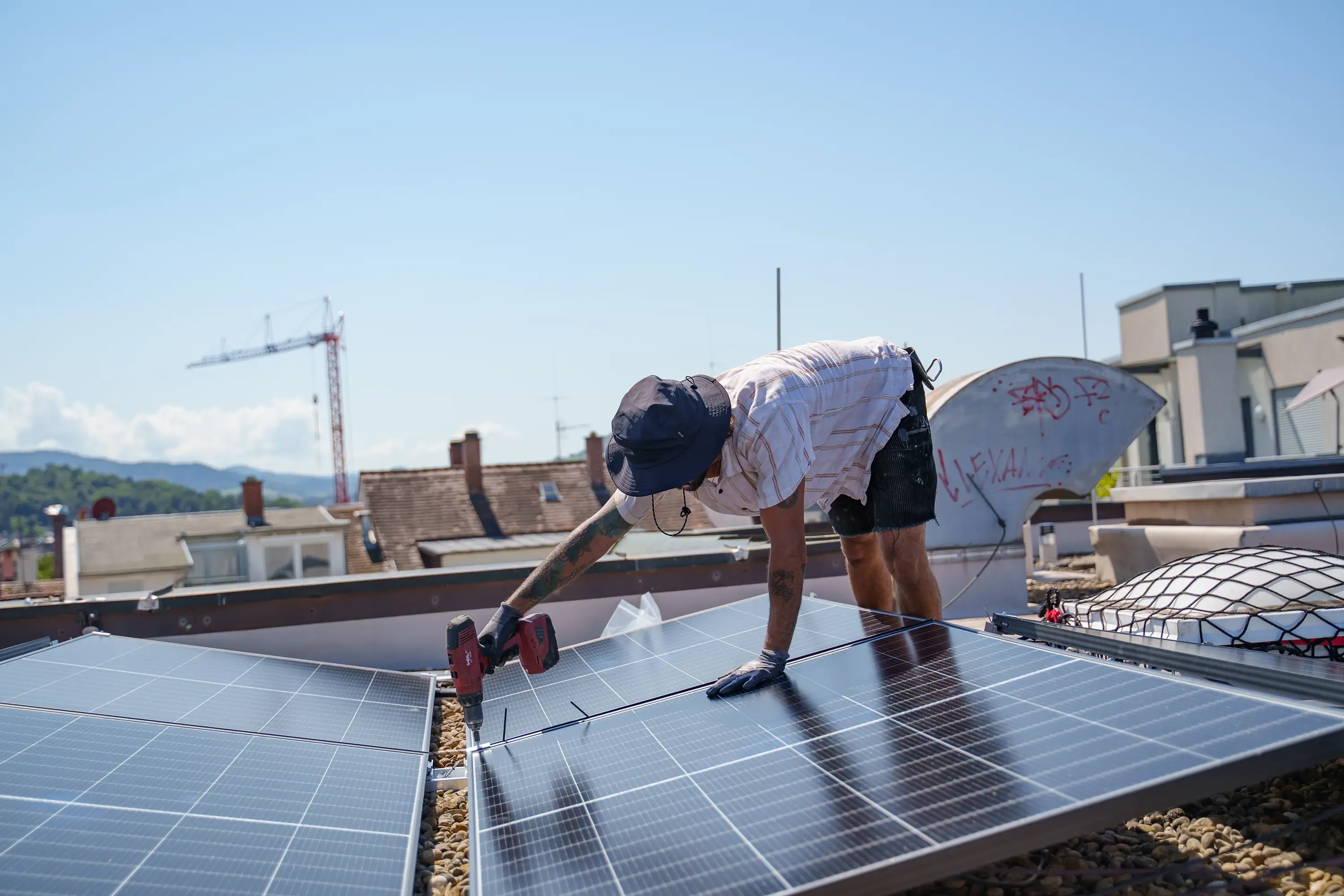 Handwerker montiert Solarmodule auf einem Dach